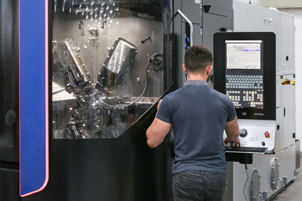 Man operating CNC lathe